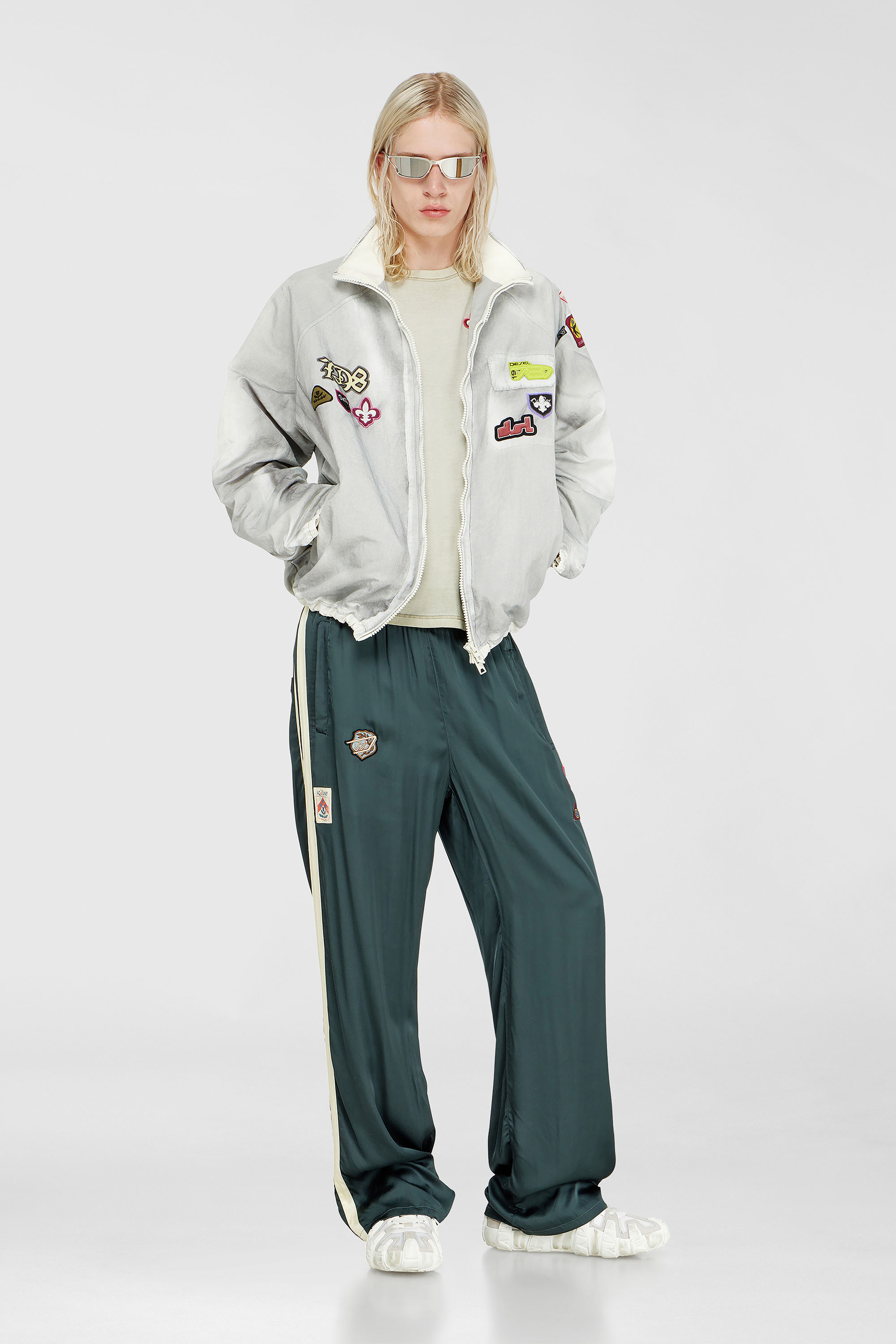 Windbreaker with trompe l&rsquo;oeil patches